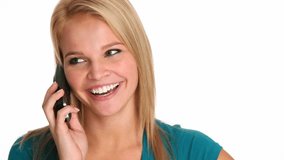 Attractive young woman talking on a cordless phone.