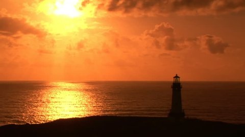 Sunset on Oregon Coast, Yaquina Head Lighthouse.  Light in lighthouse is animated
