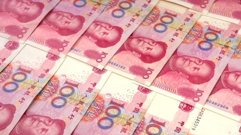 Chinese banknotes. Banknotes lie on the table and fall from above. Rotation 360