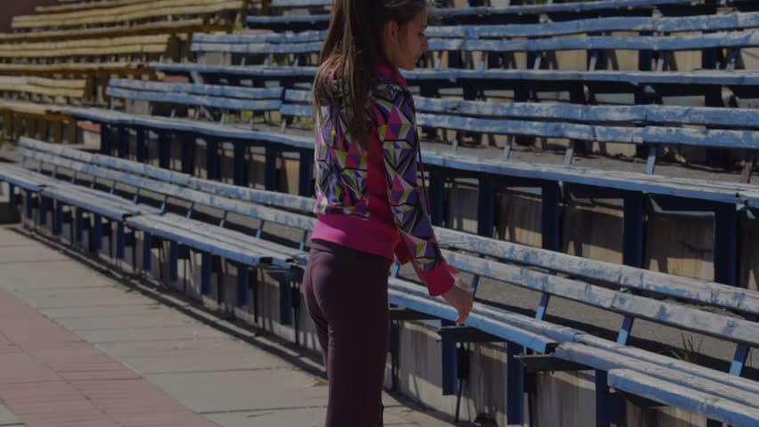 young girl doing gymnastics exercise at the track