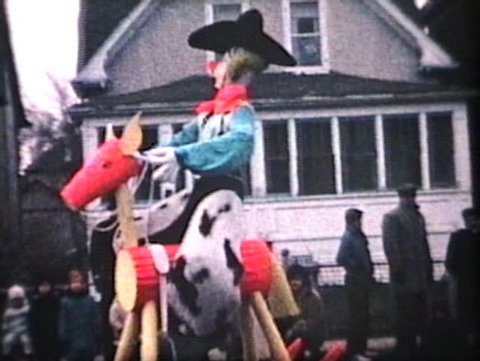 WINNIPEG, CANADA - CIRCA 1964: A band of crazy cowboys and other performers make a surprise visit in downtown Winnipeg during the annual Santa Claus parade circa 1964 in Winnipeg, Manitoba, Canada.