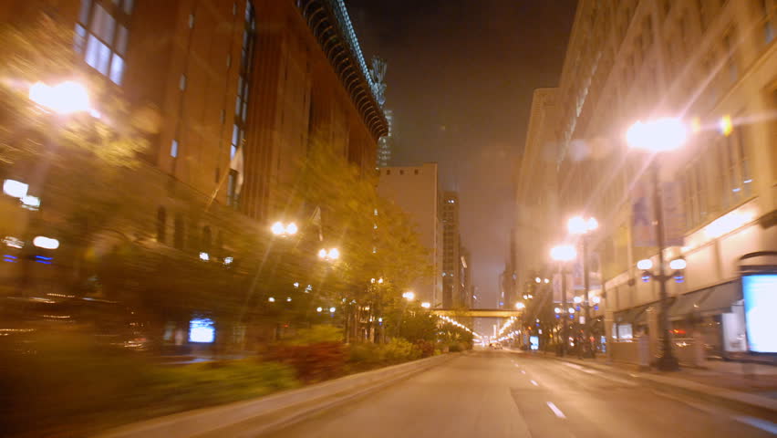 Driving through city streets at night time lapse