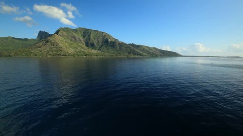 Island of Moorea, French Polynesia.  Filmed while approaching the island via vessel.  Vantage point of entering the lagoon with gentle forward movement.
