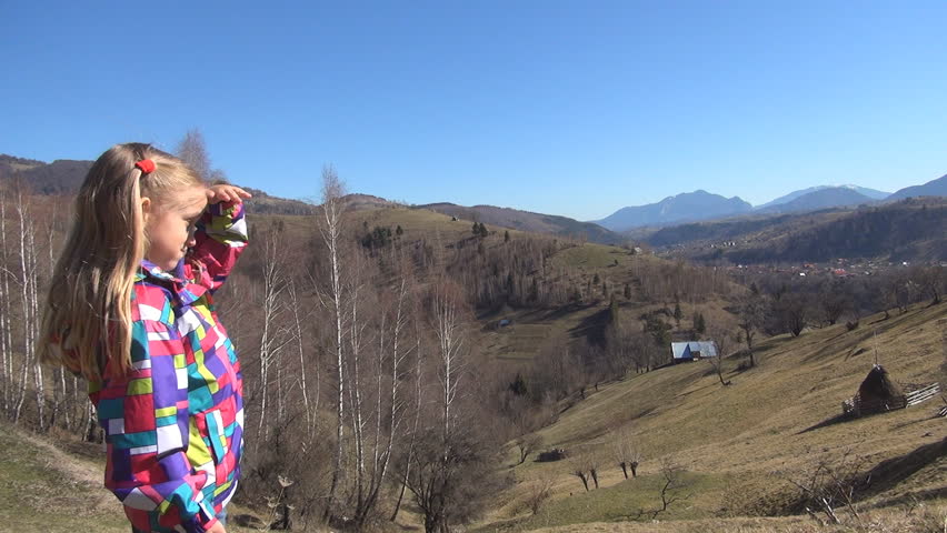Tourist Little Girl Shading her Eyes Looking at Mountains Landscape in a Trip, Kid in Vacation, Child