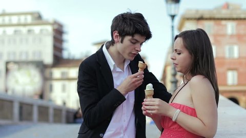 bad joke - girl spreads ice cream cone in the face of a boy - laughing