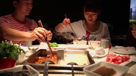 Friends eat hot pot in restaurant ,China. 库存视频