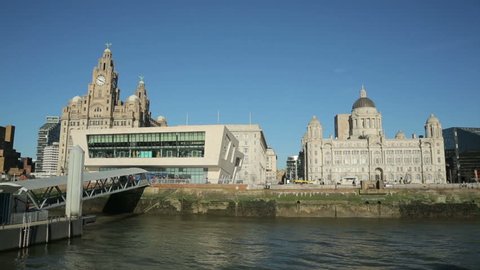 Tracking clip of Pierhead buildings taken from moving ferry as it approaches Liverpool waterfront skyline, England