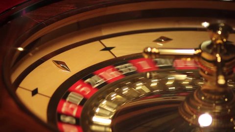 A shot of a casino roulette in motion,the ball stops at red thirty six/Better luck next time
