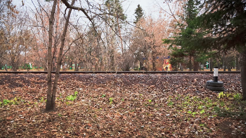 Walk Along The Rails, Man and woman walking in the autumn park 