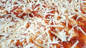 Pizza preparing adding cheese in high definition 1920x1080 FullHD footage - Pizza with cheese HD high resolution close up footage