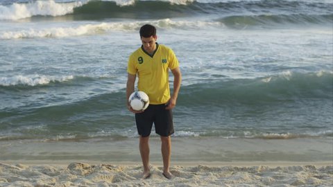 WS A young man practices his soccer skills on Ipanema Beach / Rio de Janeiro, Brazil