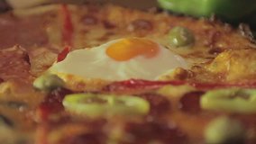 Pizza, multiple clips, camera dolly, slider, HD, cinestyle slow motion. Decorated pizza on a wooden plate.