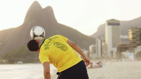 A young man practices his soccer skills on Ipanema Beach / Rio de Janeiro, Brazil