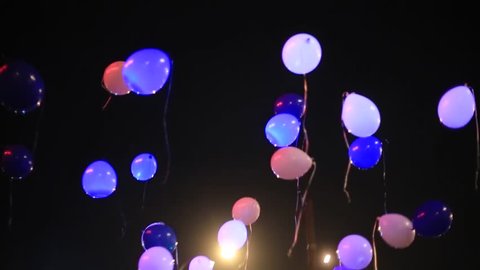 Balloons, celebration, children's party, holiday, festivity, holiday. Balloons flying in the sky at night with lights inside. Positive, good mood and beauty. Night, holiday, beauty, good mood.