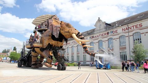 NANTES, FRANCE - JUNE 25. The giant elephant machine carries 50 passengers at a time, trumpeting and spraying water from his trunk on children and other visitors - Nantes in France 25. june 2013.