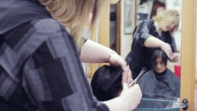 woman with very short hair at the hairstylist - hairdresser