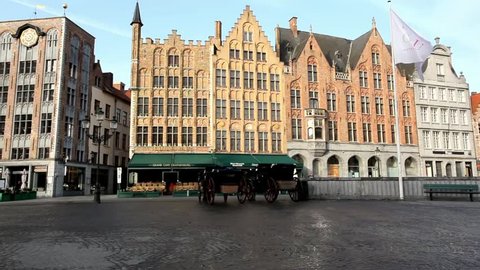 Horse carriages in the main Market square of Bruges Belgium