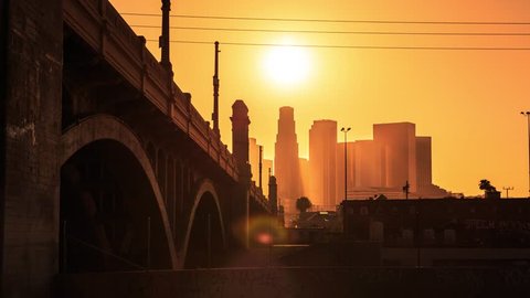 4K. Los Angeles city. Sunset sun setting into downtown LA skyline. Timelapse in motion (hyperlapse).