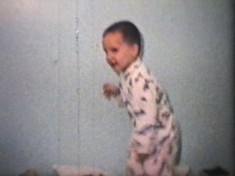A little play blows off steam by jumping on his bed and has a lot of fun doing it. (Vintage 8mm film)