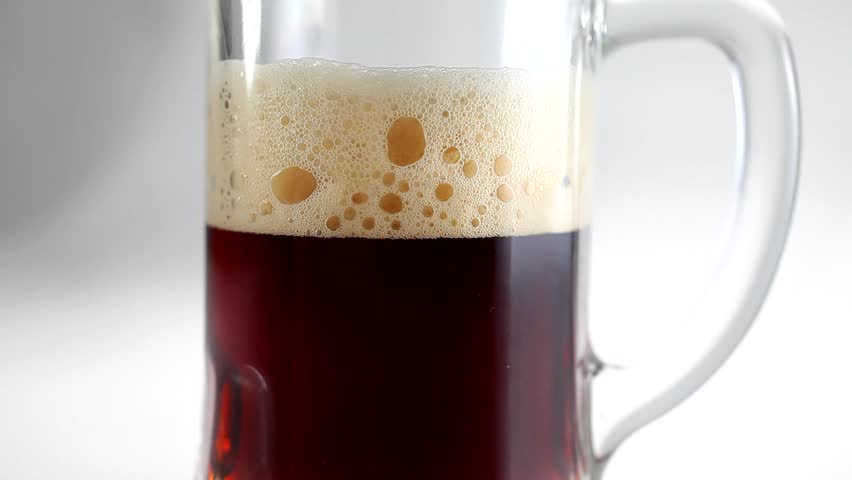 Beer pour in glass beer mug closeup