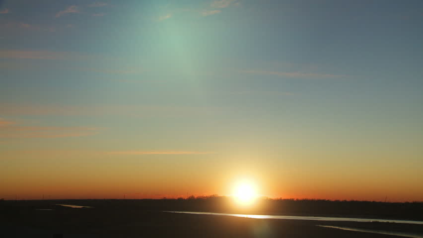 Midwestern Magic Hour Time-lapse. Beautiful and serene time-lapse of the sun beginning to set against the faded horizon in Wichita, Kansas, Midwestern United States.
