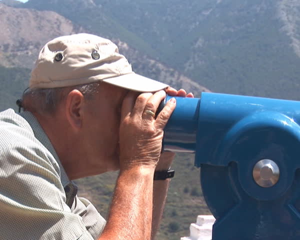 PAL: Man looking through telescope