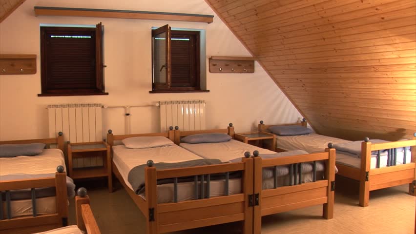 Teenagers enter their shared bedroom with their luggage