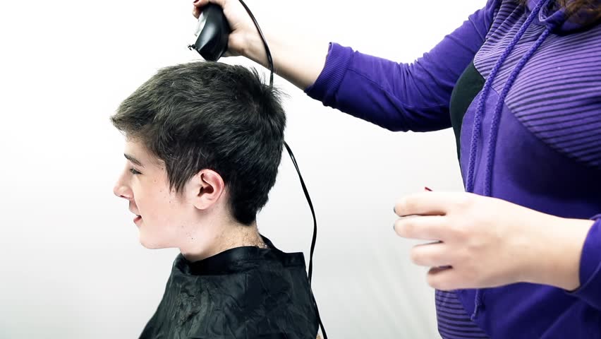 boy getting haircut with clippers