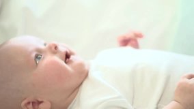 Newborn baby smiling. Close-up. Healthy Adorable Infant Laughing. Slow motion Video Footage full hd 1080. High speed camera 240 fps