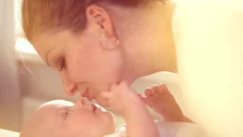 Mother and her Newborn Baby. Happy Mother and Baby kissing and hugging. Resting together. Maternity concept. Parenthood. Motherhood Beautiful Happy Family Footage. Full HD 1080 Slow Motion 240 fps Stock Video