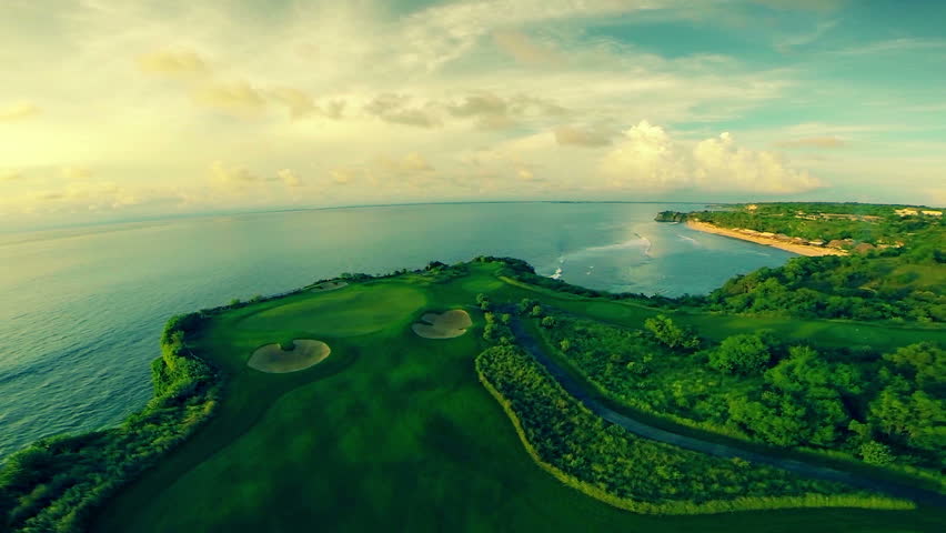 Aerial shot of a beautiful golf course surrounded by the crystal clear indian