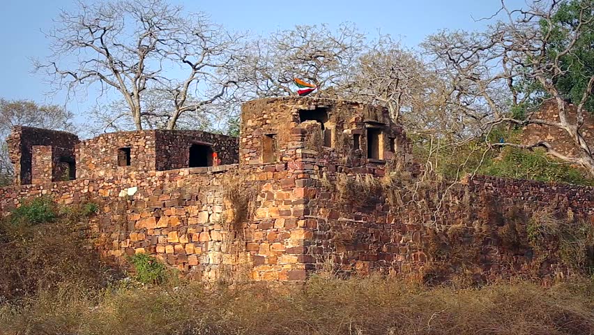 A flag waves in the wind atop Ranthambore Fort in Ranthambore, India. Founded in 944 by the Nagil Jats. One of the six forts included in the World Heritage Site inscription Hill Forts of Rajasthan.