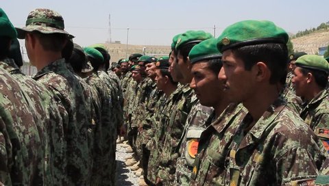 Afghanistan, Circa 2011: Pan shot of rows of Afghan soldiers in formation wearing camouflage and berets in Afghanistan, Circa 2011