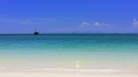 Sandy beach in Thailand. Clear ocean water, blue sky and boats. Holiday HD video footage