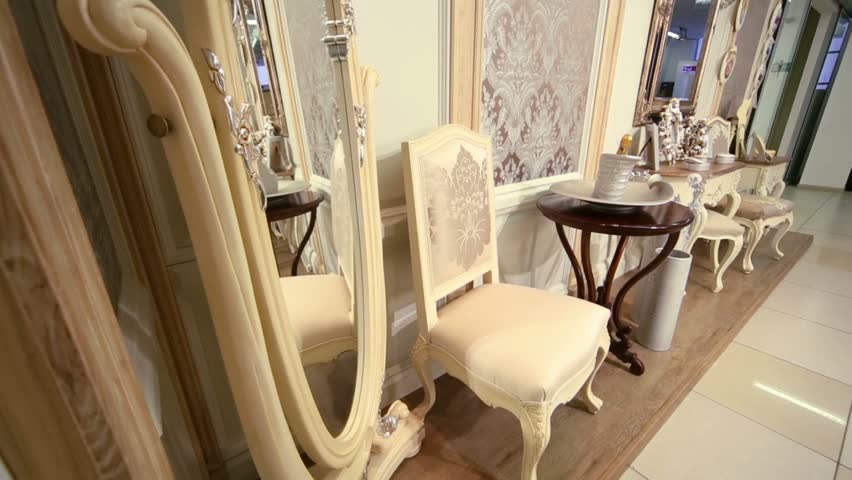 Pavilion in shopping center representing wooden chairs, mirrors and tables