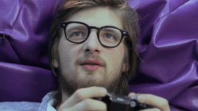 Handsome guy playing console game, addicted to computer games