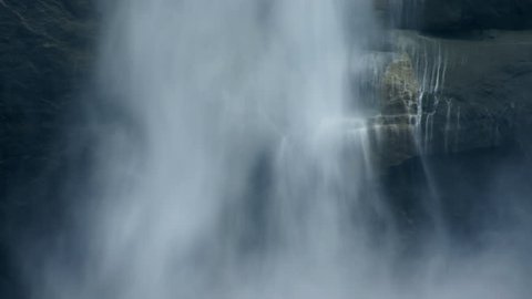 Close-up of a waterfall cascading over a sheer cliff face.