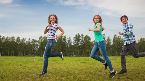 Teens Running Through the Meadow, young people having fun