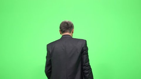 A man in a suit dancing isolated on a green chroma key/Dance and be happy
