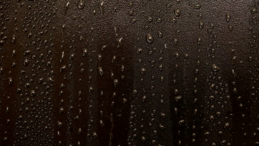 closeup of raindrops on black surface