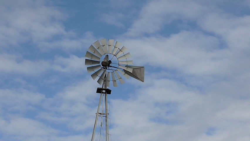 Windmill and Sky A windmill is a machine that converts the energy of wind into rotational energy by means of vanes called sails or blades