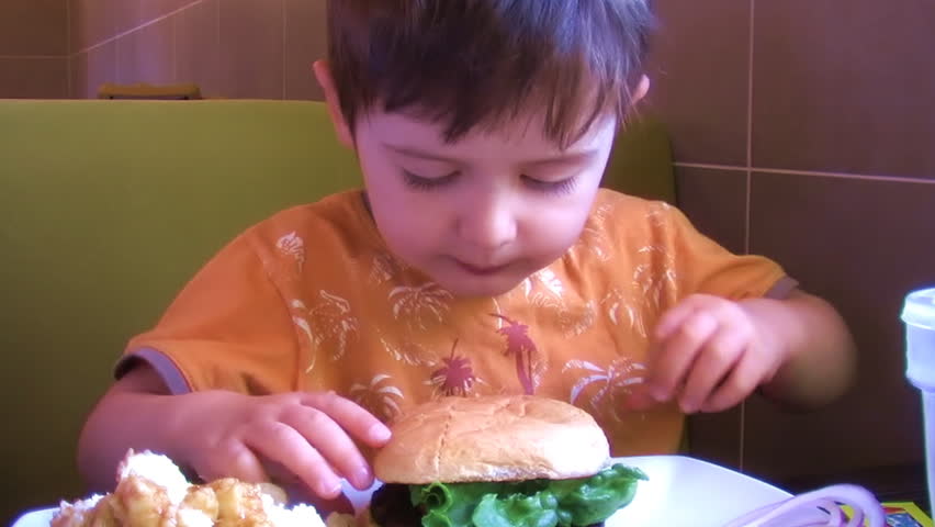 child eating hamburger