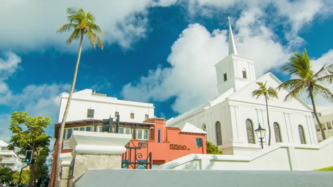 Panning Towards The Wesley Methodist Church in Hamilton, on a Sunny Day in Bermuda with Green Trees and White Clouds in a Blue Sky.