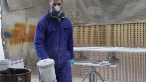 painter in a factory - industrial painting with spray gun - dolly