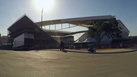 Arena Sao Paulo, Itaquera, Sao Paulo, Brazil, side of stadium, sun backlight, worker walking, shooting 04/29/2014