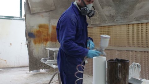 painter in a factory - industrial painting with airbrush - dolly