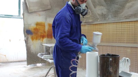 painter in a factory - industrial painting with spray gun - dolly