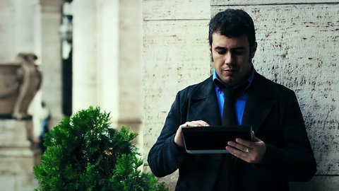 businessman holding and touching on digital tablet pc outdoor