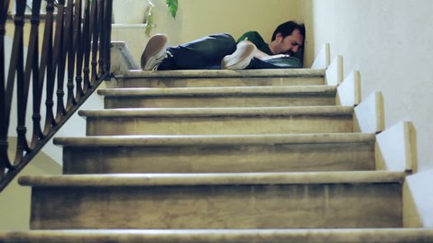 Unconscious man lying on a staircase
