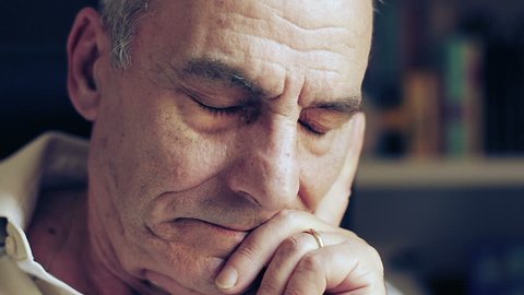 pensive and sad old man looking at the camera - depressed